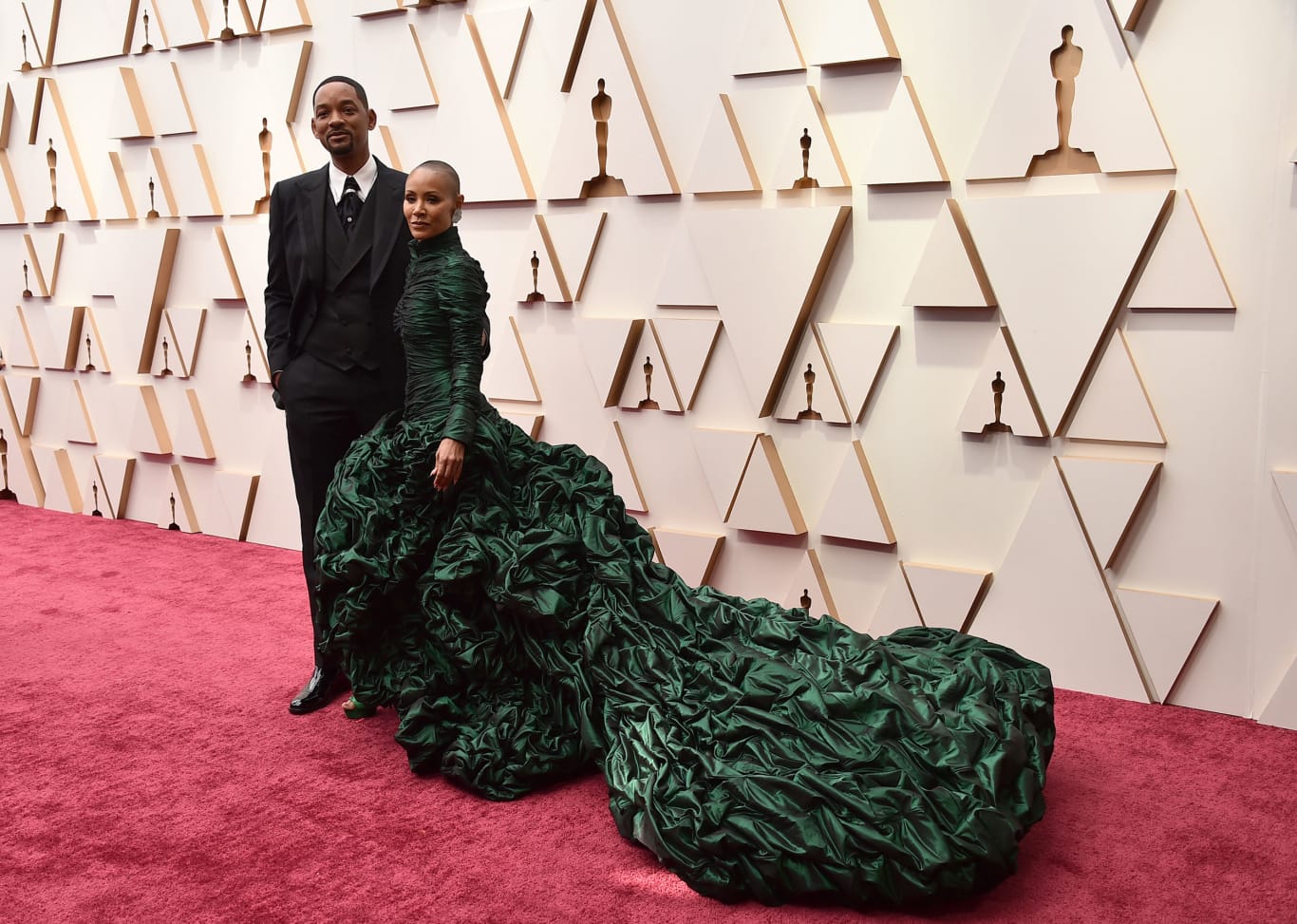 Will Smith, who won Best Actor for his role as Richard Williams in "King Richard," arrived on the carpet wearing Dolce & Gabbana, accompanied with Jada Pinkett Smith in a voluminous emerald green gown.