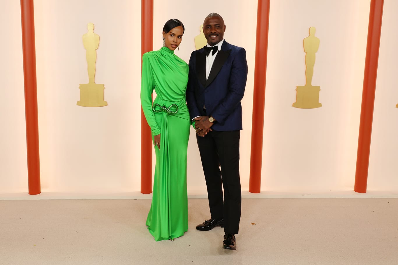 Sabrina Dhowre Elba, pictured alongside husband Idris Elba, turned heads in a bright green draped gown by Stella McCartney. 