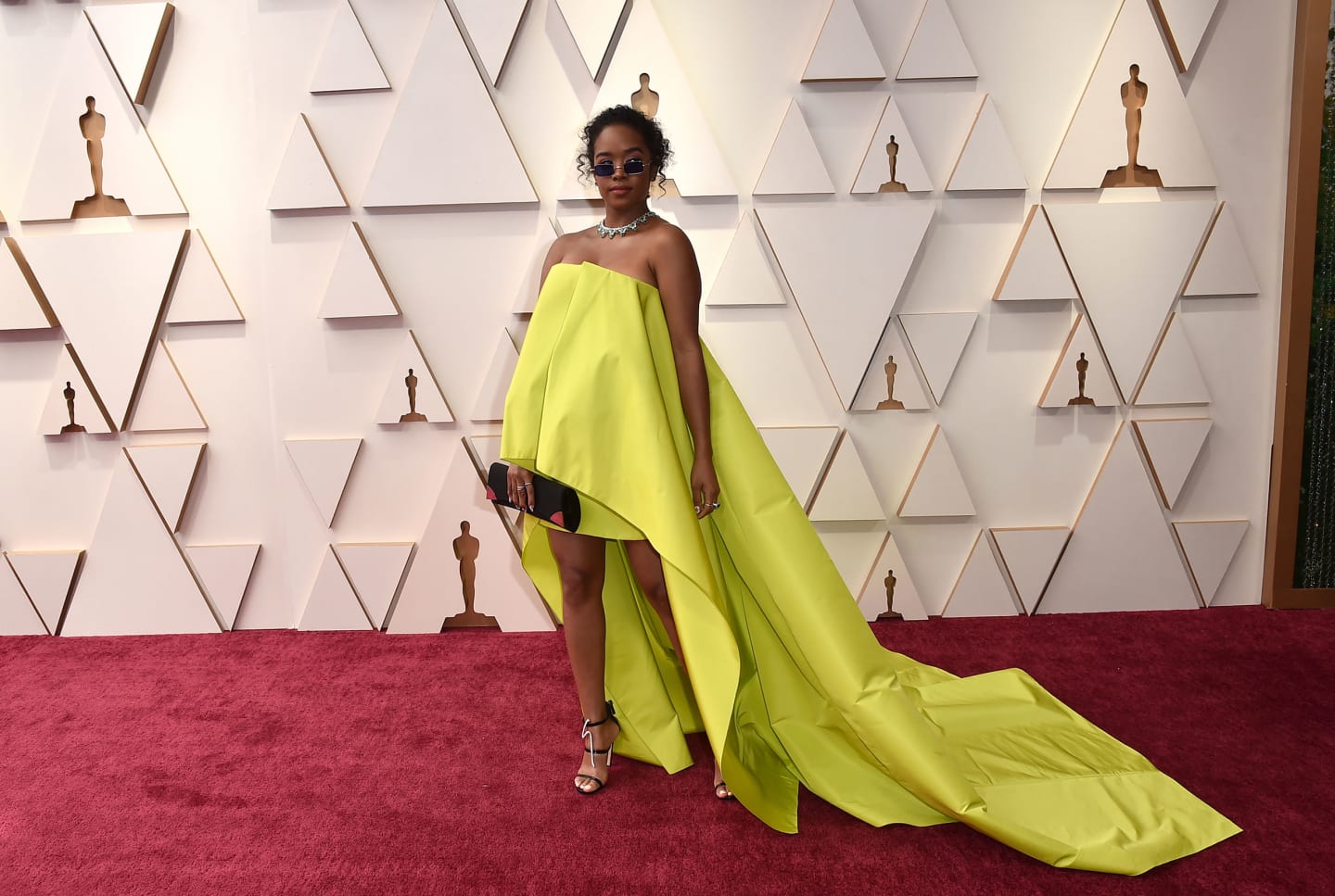 Singer H.E.R. in a bright strapless gown and long train. 