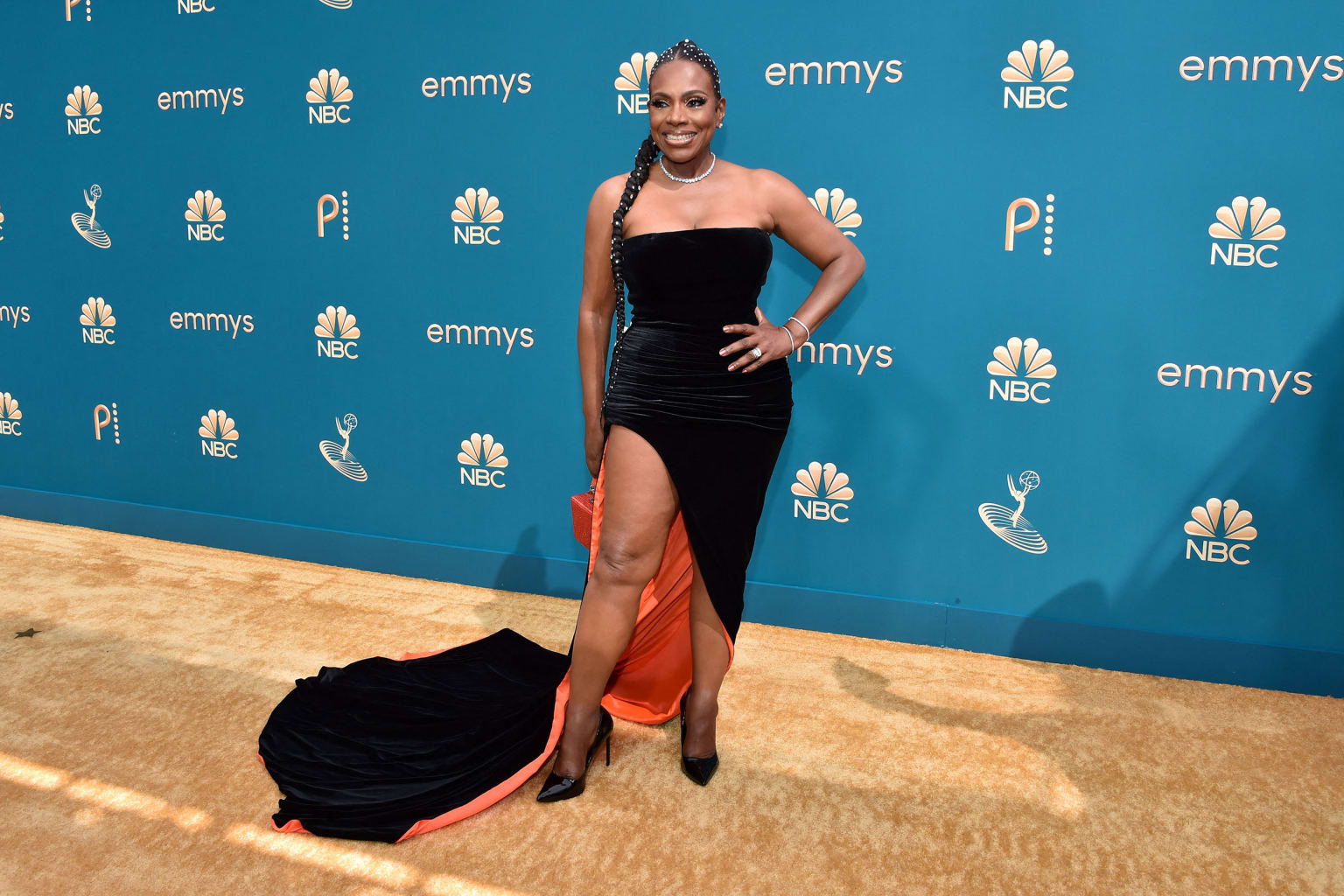 Sheryl Lee Ralph, nominated who took home an Emmy for her turn in "Abbott Elementary," wore a velvety gown with a long train and contrasting orange lining. 