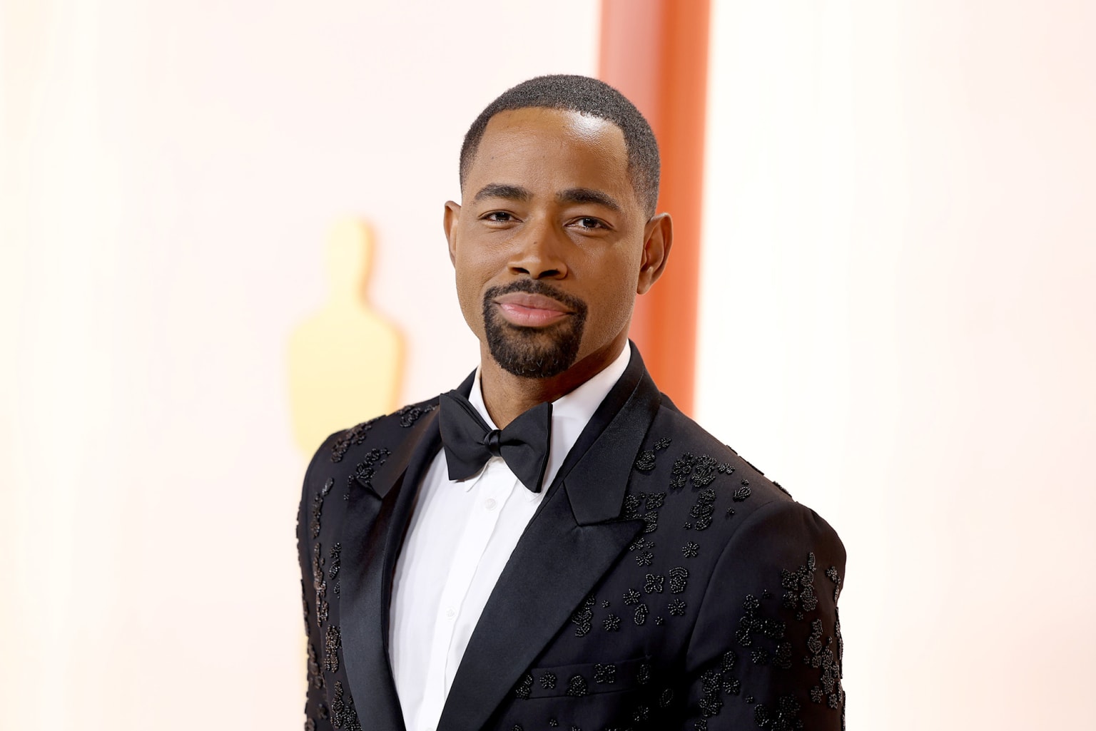 Jay Ellis in a black tuexedo with beaded floral appliqué by Fendi. 