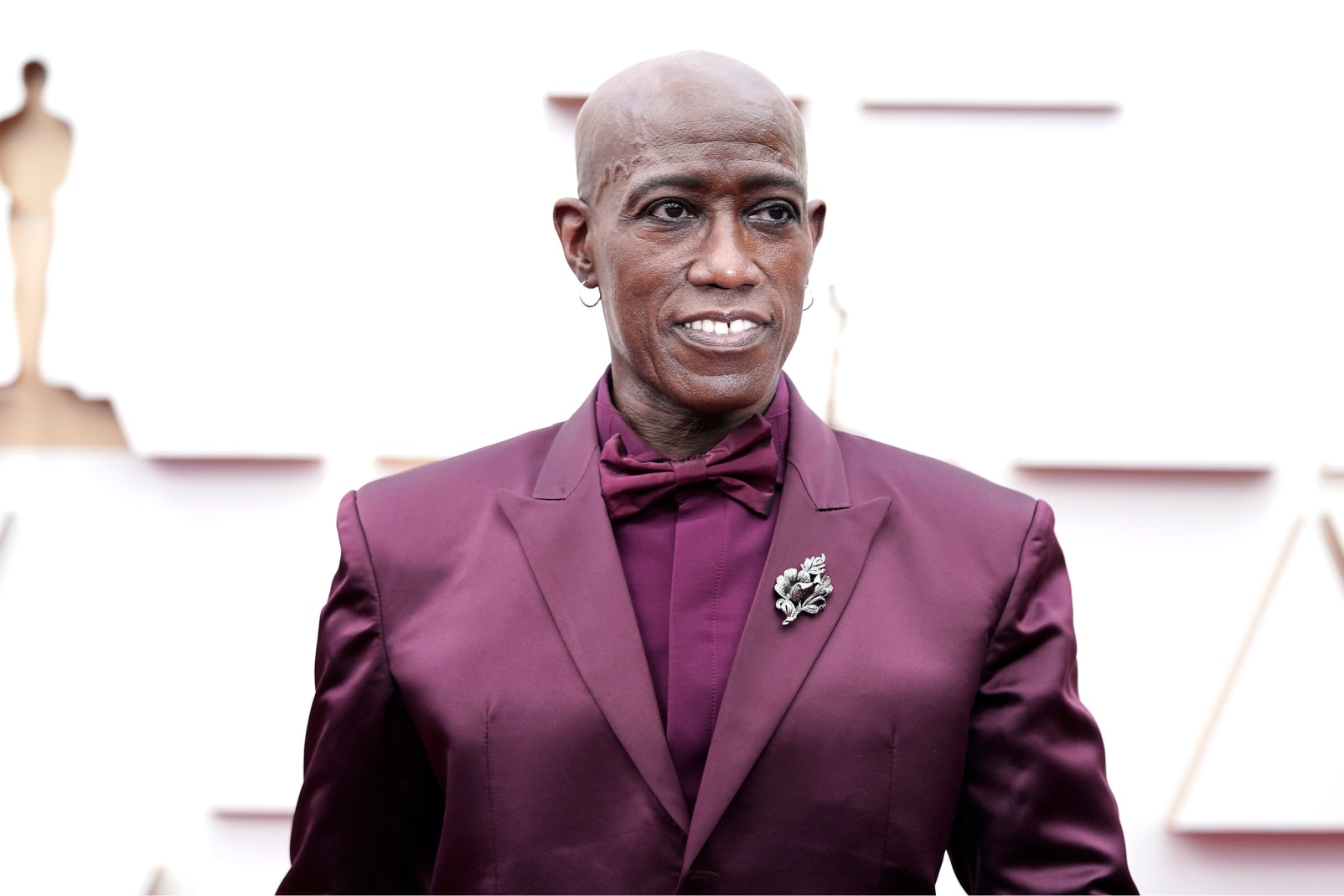 "Coming 2 America" actor Wesley Snipes in a custom Givenchy maroon look paired with silver hoop earrings.