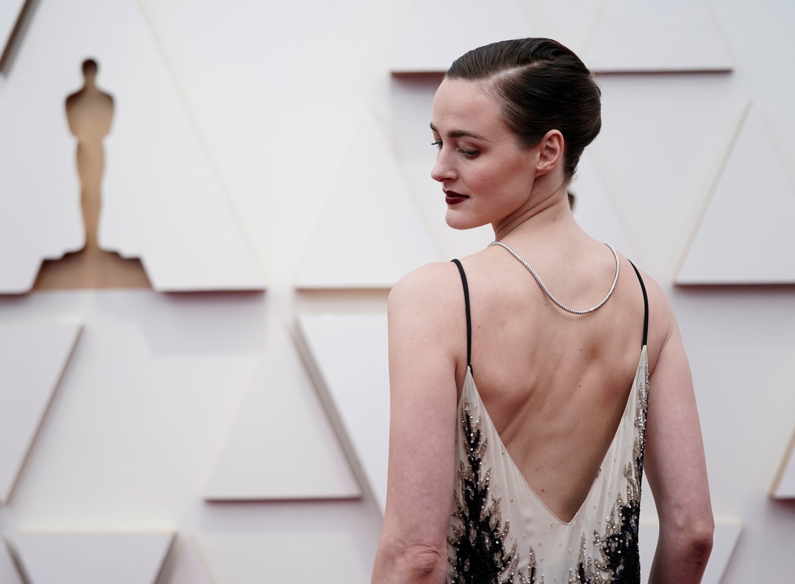 "The Worst Person in the World" star Renate Reinsve's Louis Vuitton lacy gown featured a low back with silver sequins.