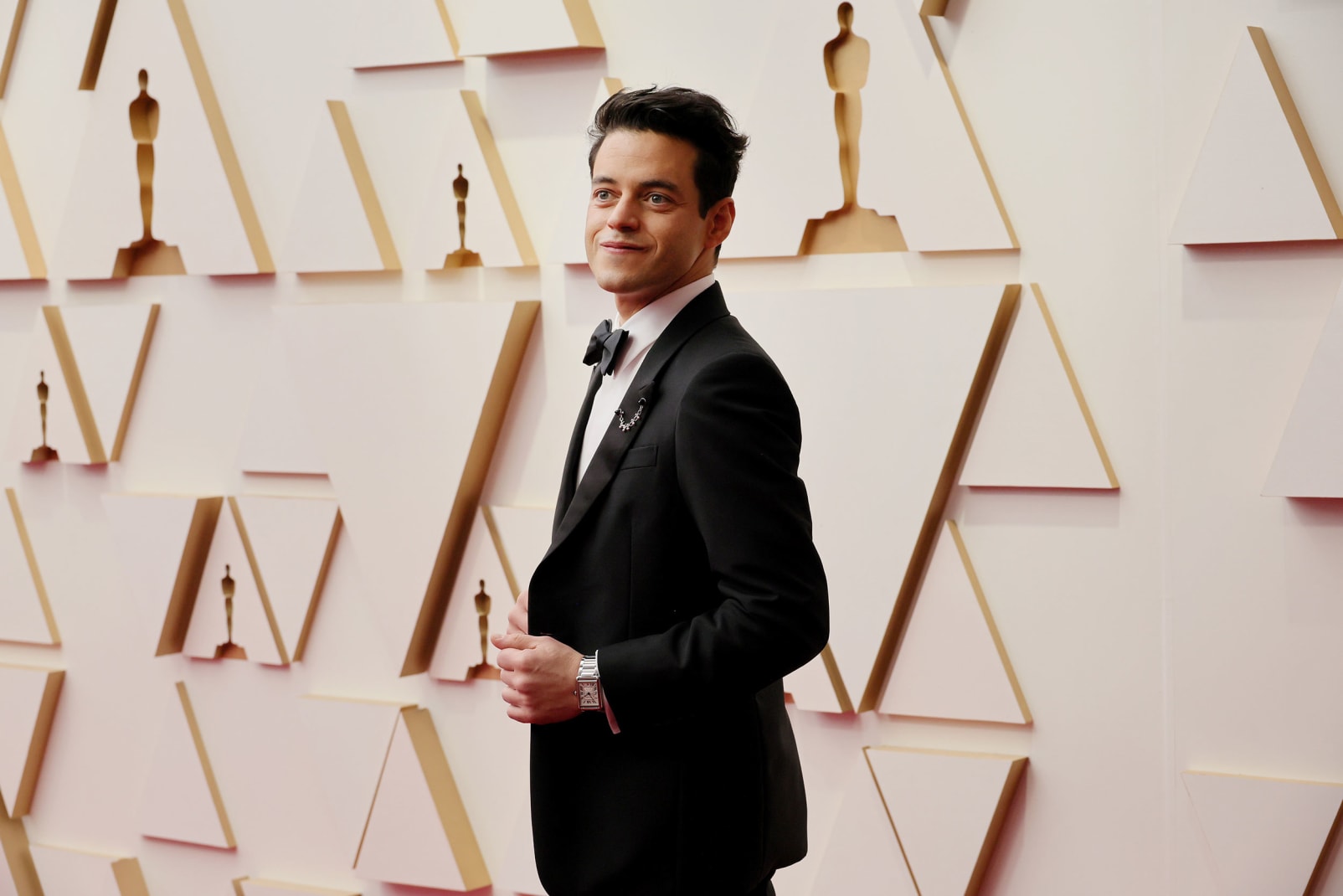 "No Time To Die" actor and Oscars presenter Rami Malek kept it chic and simple in a black Prada tuxedo. 