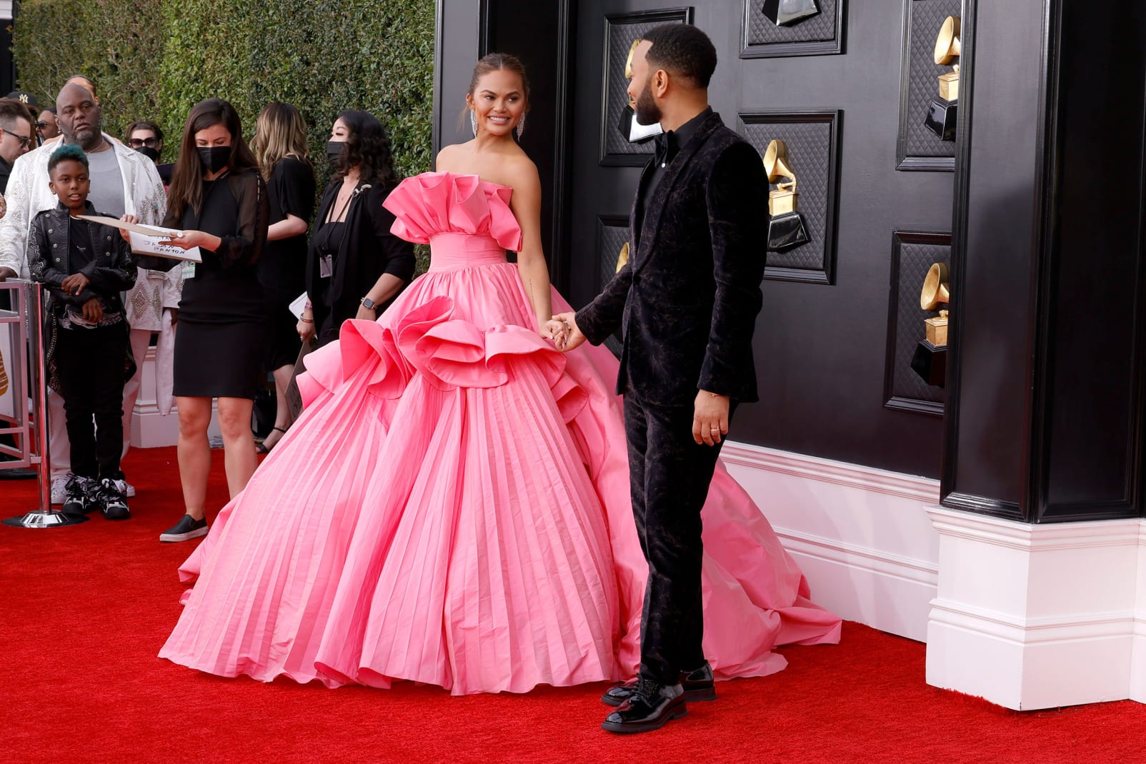 Chrissy Teigen was one of many pink looks of the night in her voluminous fan dress, while John Legend wore a velvet black suit by Zegna. 
