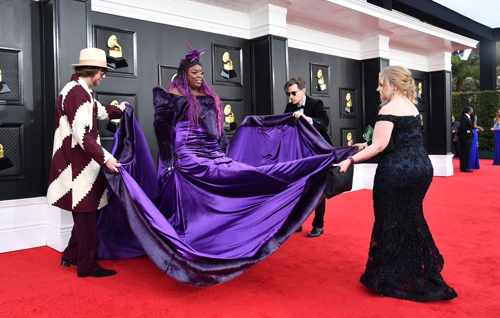 Singer Yola needed help from several other attendees to unfurl the full splendor of her bold, head-to-toe purple outfit. 