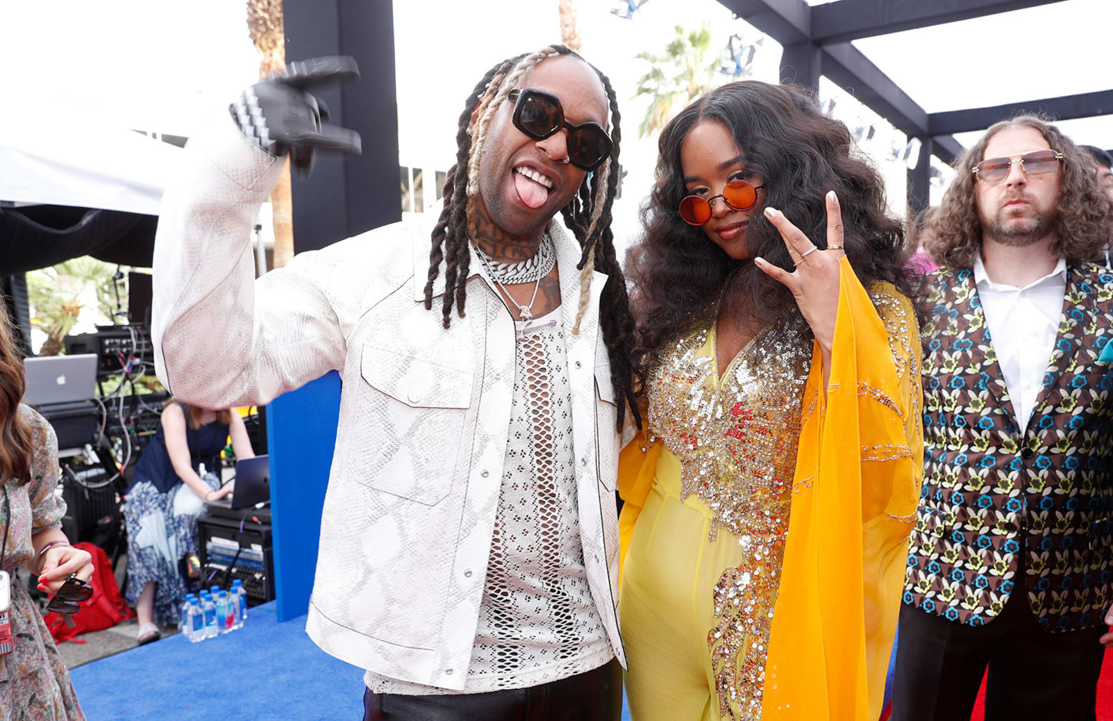 Ty Dolla $ign and H.E.R, who wore a custom yellow-and-orange kaftan jumpsuit by Dundas. 