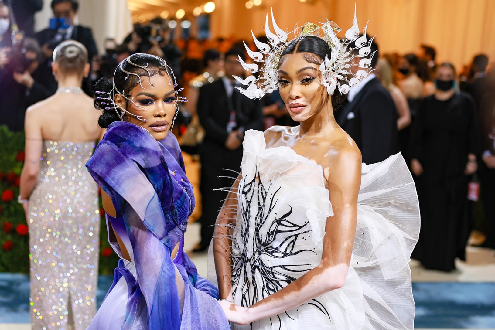 Winnie Harlow and Teyana Taylor dazzled in Iris van Herpen ensembles and headpieces. Harlow opted for a black-and-white sculptural dress, while Taylor wore a gauzy purple gown. Taylor told Vogue on the red carpet that it was a "futuristic" take on the "Gilded Glamour" theme but also like the villain Ursula from "The Little Mermaid."
