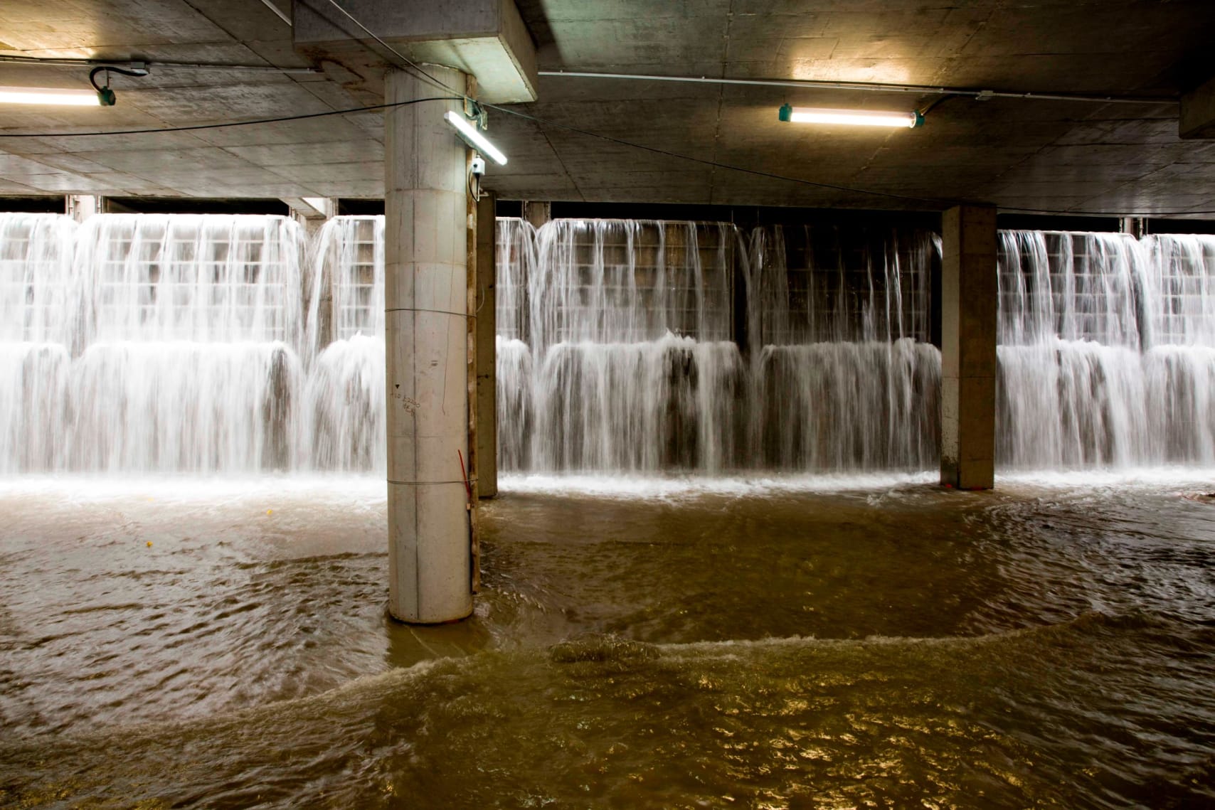 Water pours into the Happy Valley rainwater storage tank during a storm.