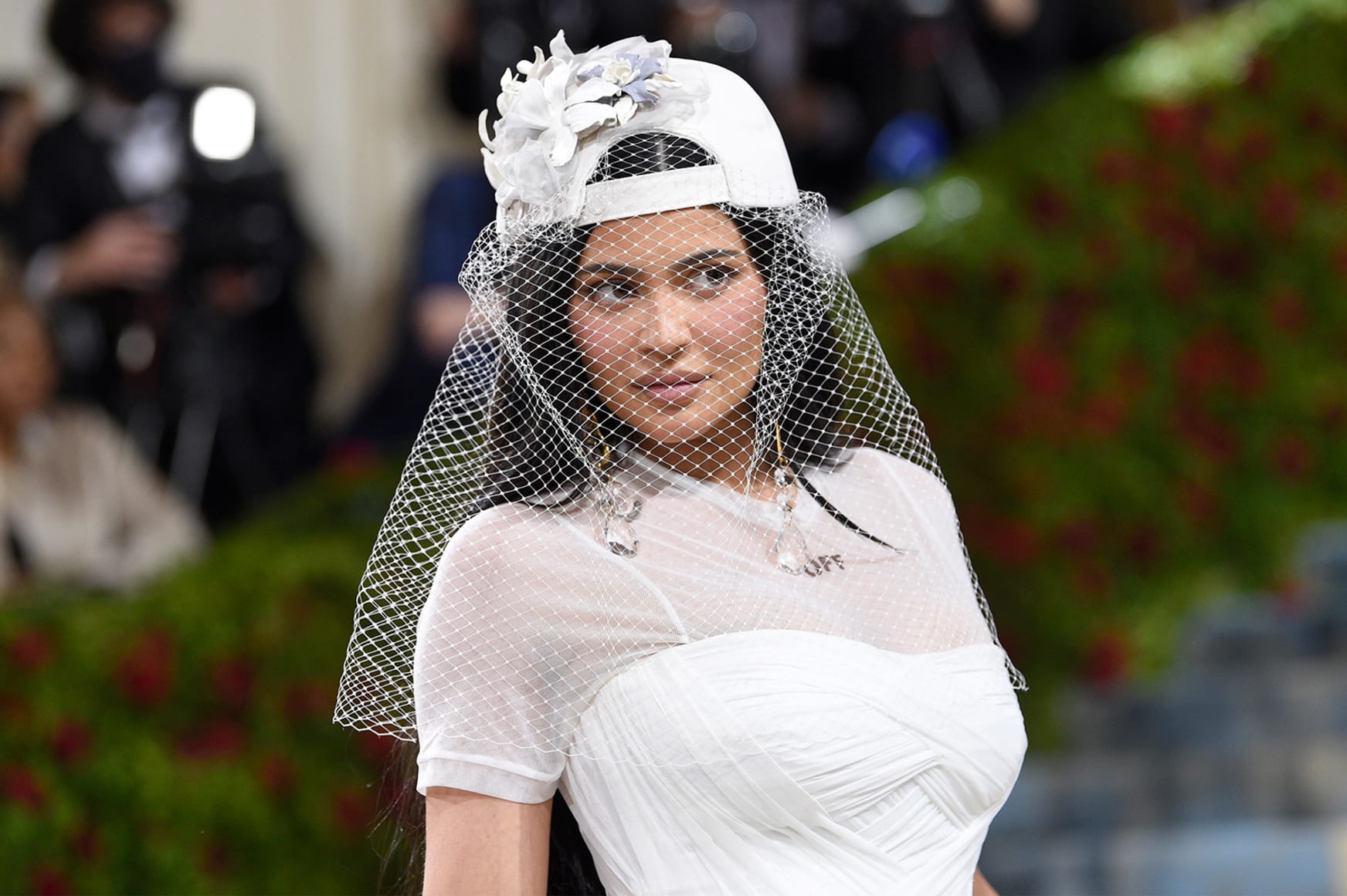Kylie Jenner gave her bridal gown a streetwear twist with a veil covering her backwards baseball cap. The outfit was designed by Off-White's late founder Virgil Abloh.