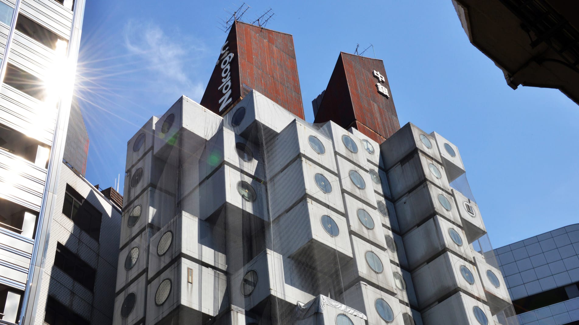 This picture taken on September 13, 2014 shows the Nakagin Capsule Tower in Tokyo. The 140 units at Nakagin represent a special part of the history of architecture and one that is worth protecting against plans to tear it down. Around half of the capsules, designed by Japanese architect Kisho Kurokawa in 1972, are currently in use as offices, art studios and second homes, but 20 of the tiny spaces are full-time homes.