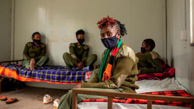 Community ranger Eunice Mantei Nkapaiya sits with her colleagues in their camp. The women were away from their families for months while they worked the bush.