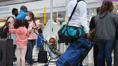 Travelers arrive for flights at O'Hare International Airport in Chicago on March 16, 2021. US airports are seeing pandemic-era record numbers of passengers.