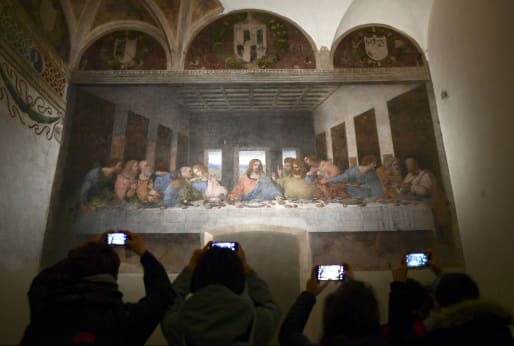 Visitors take photos of "The Last Supper" ("Il Cenacolo or L'Ultima Cena") at the Convent of Santa Maria delle Grazie in Milan, Italy.