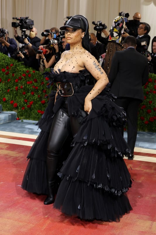 Nicki Minaj stepped out in a custom Burberry look by Ricardo Tisci which featured a black leather baseball cap, tiered gown and sparkling body crystals.