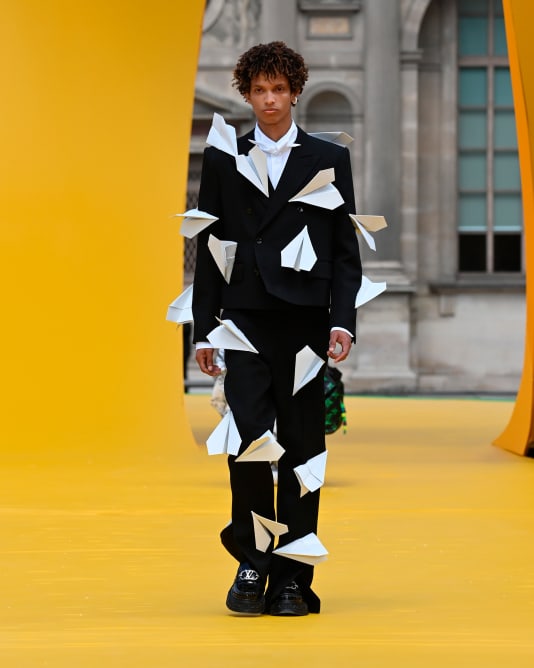 Paper planes were fastened onto suits in the latest Louis Vuitton collection.