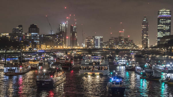 Boats line up in the Thames after watching New Years Eve fireworks in London, England. 