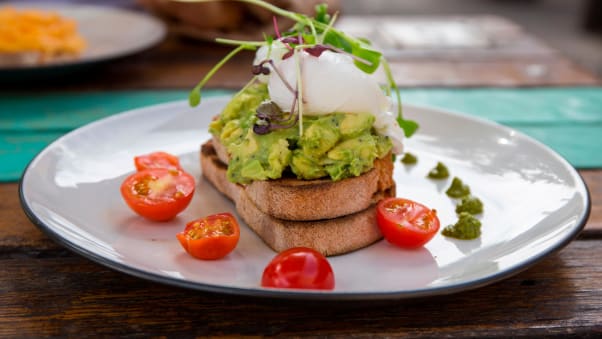 Smashed avocado and poached eggs with cherry tomatoes is an Australian original -- a popular option when hungover too.