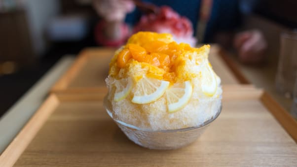Mixed citrus syrup is poured over shaved ice in this Japanese kakigori.