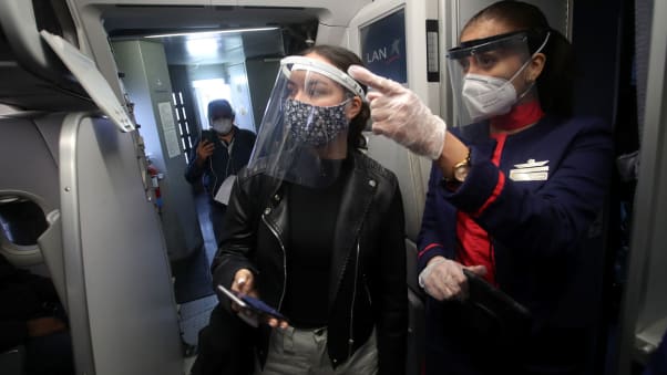  A crew member gives instructions to a passenger boarding the flight LA 2212 between Lima and Trujillo, Peru on July 15