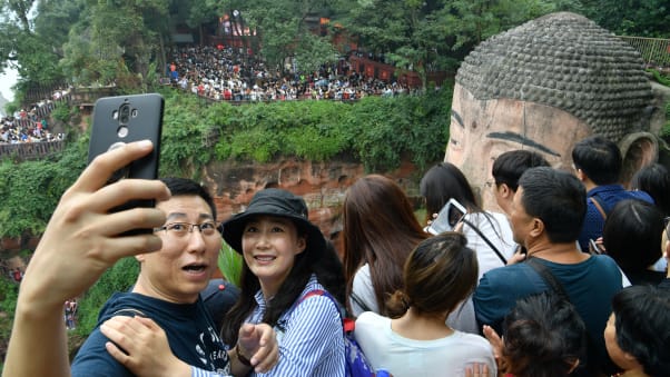 Tourists crowd the Leshan Giant Buddha in China's Sichuan province during the National Day holiday in 2019.