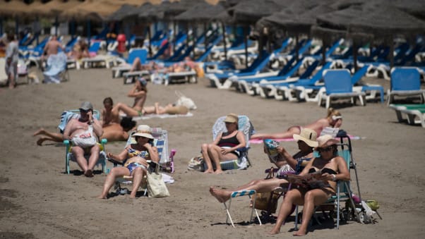 Tourists sunbathe at Marbella beach on June 7, 2021 in Marbella. - Spain opened its borders to vaccinated travellers from all over the world, hoping an influx of visitors will revitalise an all-important tourism sector that has been battered by the coronavirus pandemic. (Photo by JORGE GUERRERO / AFP) (Photo by JORGE GUERRERO/AFP via Getty Images)
