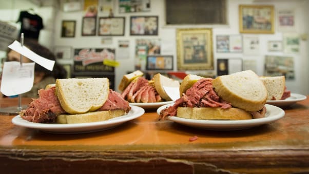 Smoked meat sandwiches, seen here at Schwartz's deli in Montreal, are piled high with smoked beef brisket.