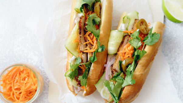 A classic bánh mì is served on French bread with grilled pork, shredded carrots, jalapeno peppers and cilantro.