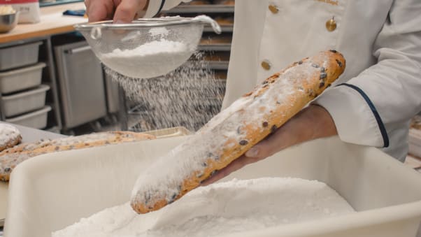 The stollen gets a generous dusting of icing sugar.