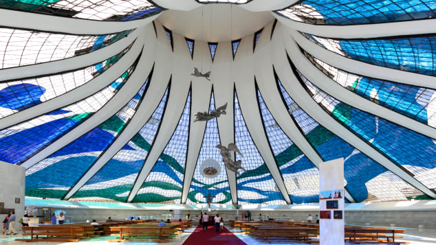 The Cathedral of Brasilia and its suspended angels are bathed with natural light shining through the stained glass.