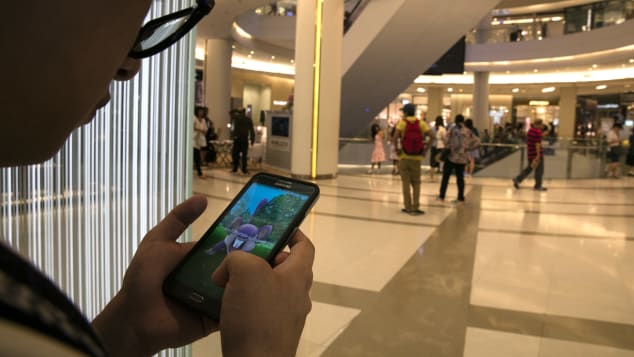 This shopper is more preoccupied with Pokemon Go than grabbing bargains.