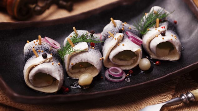 Rolled herring in vinegar, served with onions and pickles. 