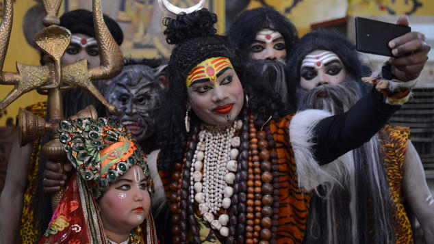 An Indian artist dressed as Hindu god Lord Shiva takes part in a procession ahead of the Holi festival in Amritsar in 2018. 