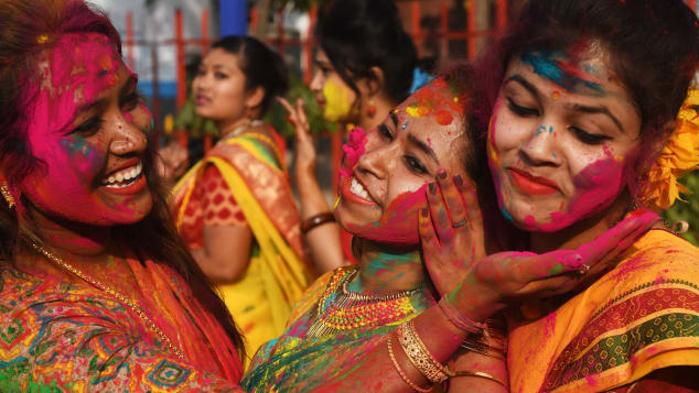Indian students smear colored powder during an event to celebrate the Hindu festival of Holi in Kolkata in 2018. 