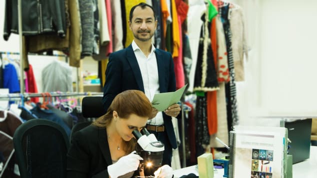 The Luxury Closet CEO Kunal Kapoor with a staff member checking the authenticity of an item.
