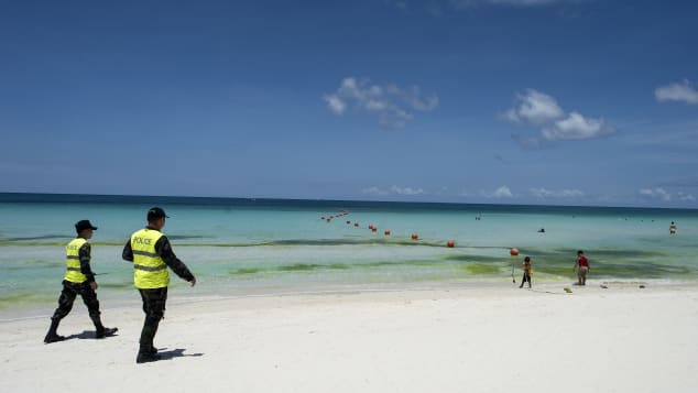 Policemen patrol on the beach on Philippine island of Boracay on April 26, 2018.