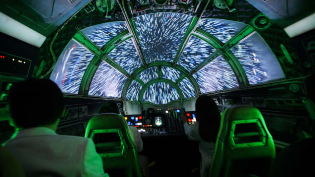 Guests sit in the Millennium Falcon: Smugglers Run ride.
