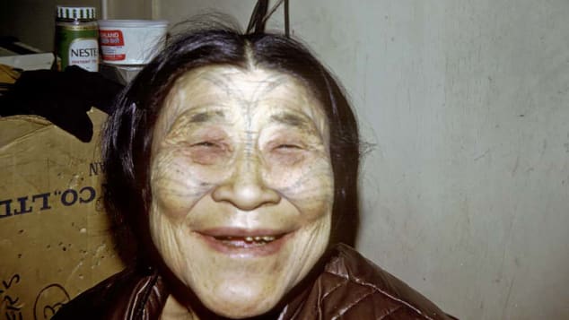 An Inuit woman with traditional tattoos on her face smiles in this 1969 archival photo from Canada's north.