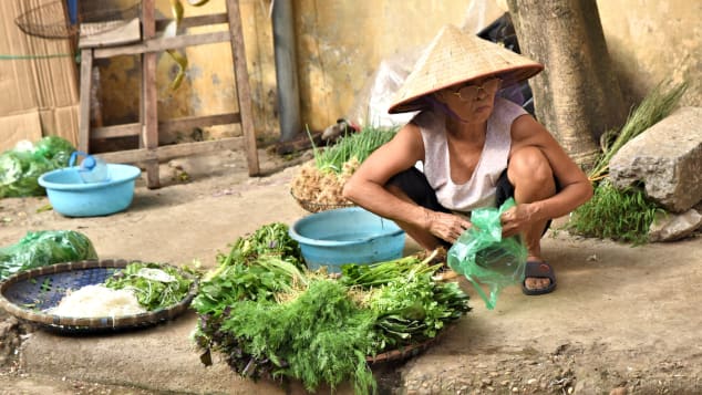 Street trader selling vegetables in Dong Ngac village