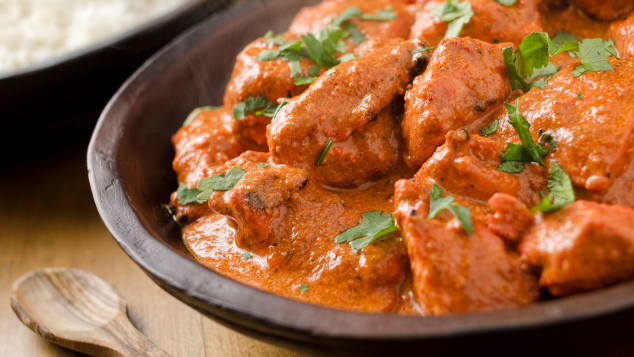 Butter chicken curry with basmati rice and limes. 