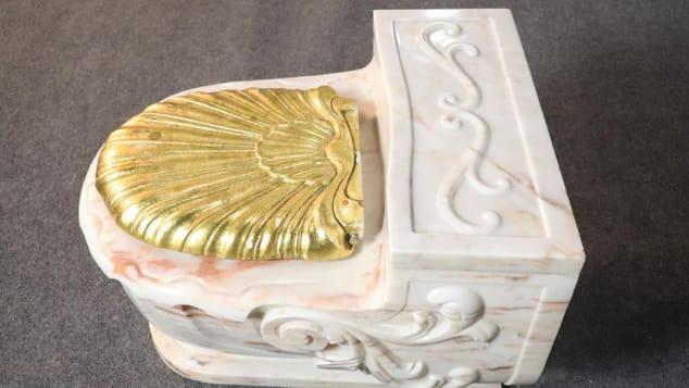 This gold-seated toilet sold for $4,250 at auction. 