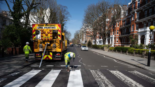 A Highways Maintenance team takes advantage of the COVID-19 coronavirus lockdown to re-paint the iconic Abbey Road crossing in London. 