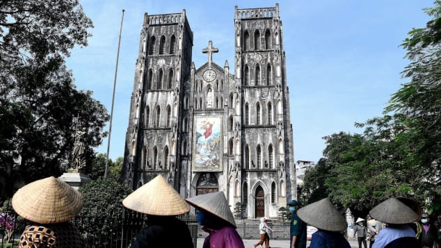 Residents stand in a queue for free rice at St. Joseph's Cathedral in Hanoi's Old Quarter on April 27, after Vietnam eased its nationwide social isolation effort.