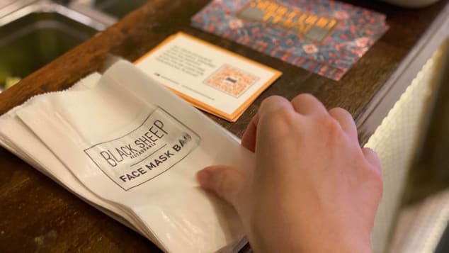 Once cleared to enter, diners at Black Sheep Restaurants' establishments can store their face masks in the provided paper bags. 