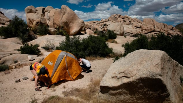 Marta Jerebets, left, and Arthur Pettit pitch their tent on a campground at Joshua Tree National Park in California on May 19, 2020.