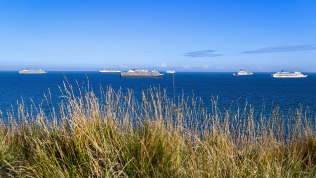 Several cruise ships are currently anchored off the English Channel. Pictured here: Queen Victoria, Queen Mary 2, Queen Elizabeth, Marella Discovery, Carnival Valor and Aurora, off the coast of Weymouth.