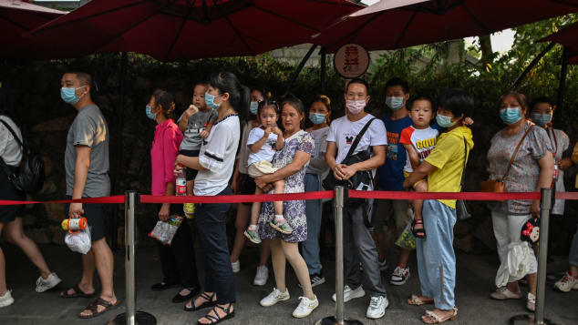 Tourists wearing face masks line up outside the Yellow Crane Tower in Wuhan, China on September 3.