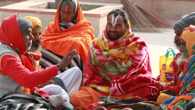 Indian Hindu devotees sit on the banks of the River Ganges in Haridwar on January 14.
