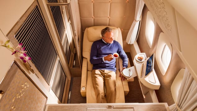 In first class suites on Emirates' Boeing 777-300ERs, a body-cradling seat reclines into a bed, which is pictured at the top of this story.