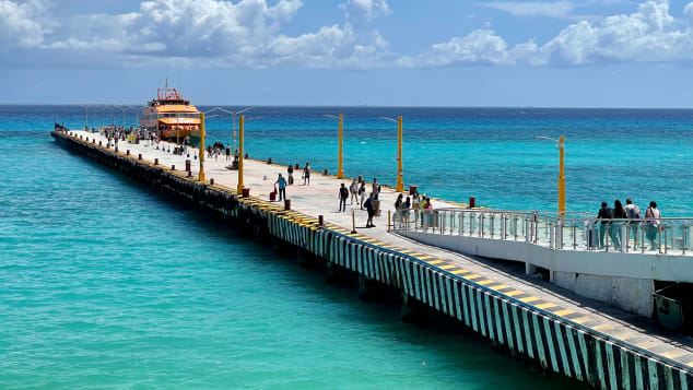 Tourists line up to board a boat in Playa del Carmen, Mexico on March 3, 2021. Mexico has some of the world's loosest travel rules.